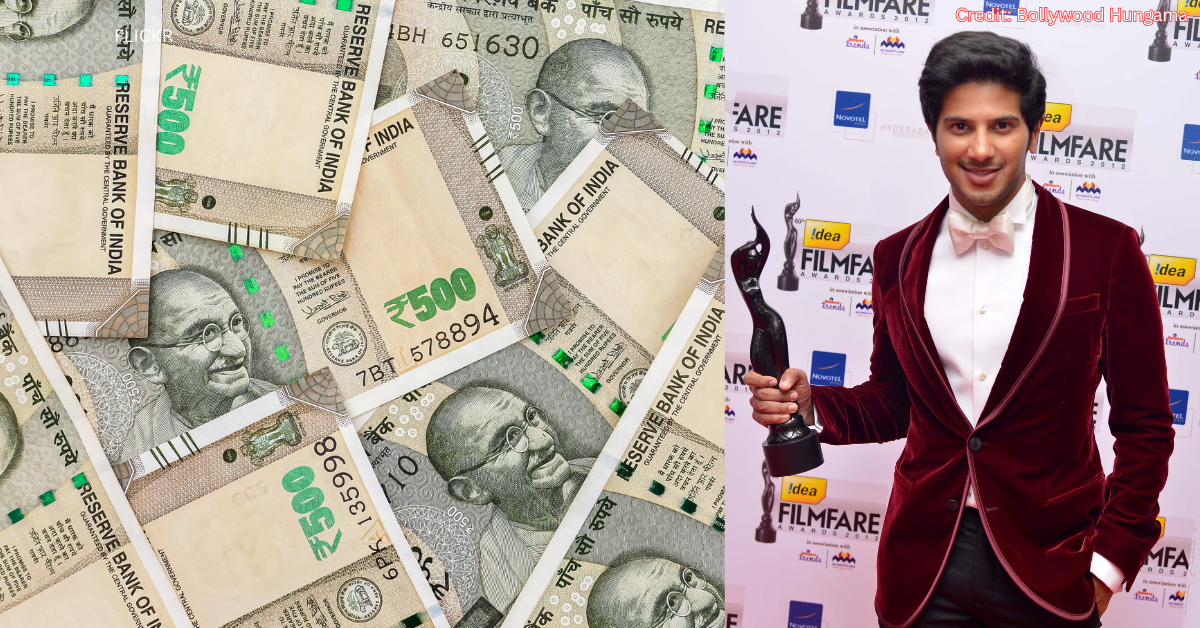 Indian 500 Rupee notes spread out, next to a photo of actor Dulquer Salmaan holding a Filmfare award on a red carpet