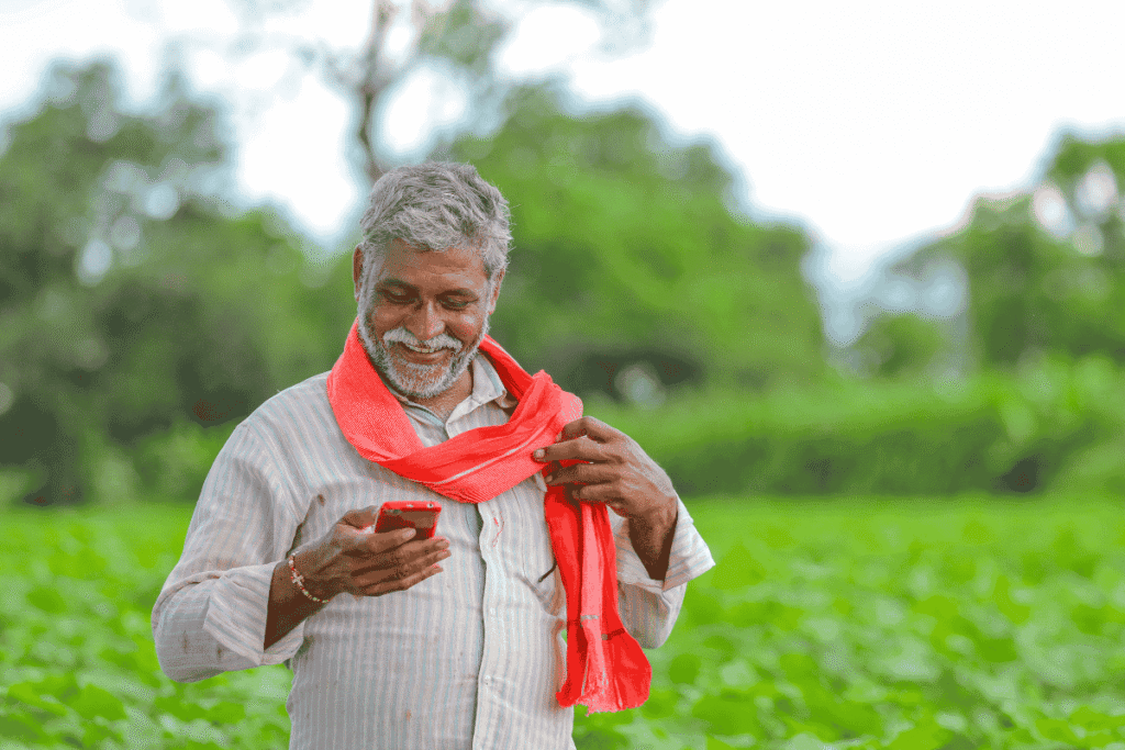PM Kisan Samman Nidhi (PM-KISAN) : A happy farmer checking mobile after receiving Rs 6000.
